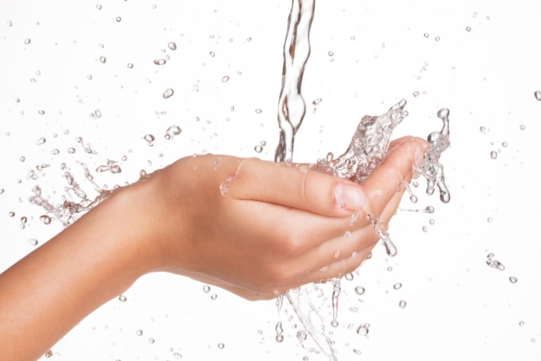 woman's hands in water stream