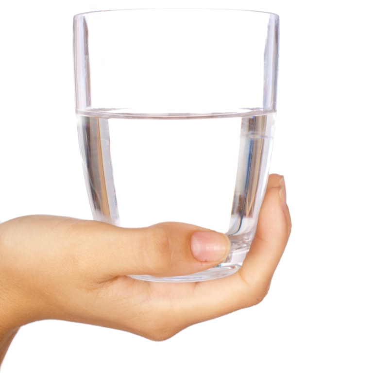 Woman's hand holding up glass of water.