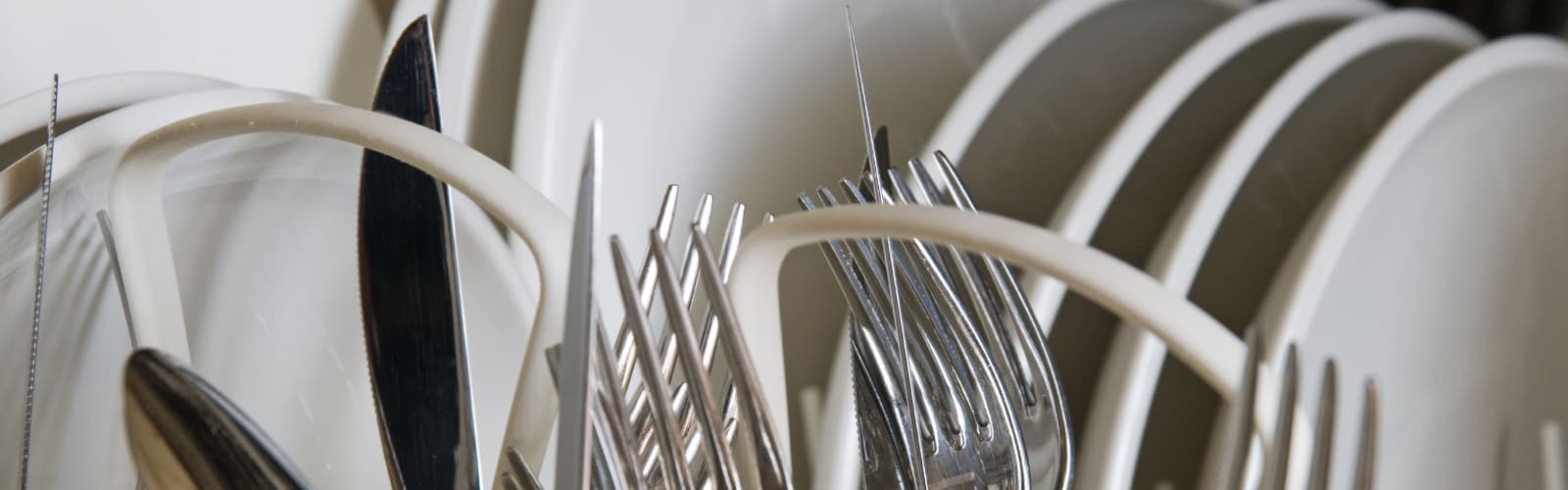 Clean cutlery in dishwasher rack.